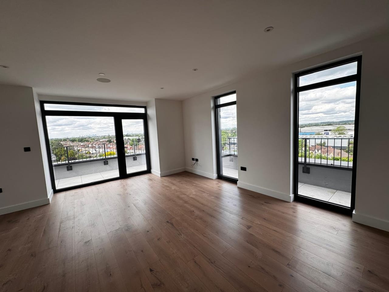 Corner living space with full-height aluminium glazing looking towards the London skyline